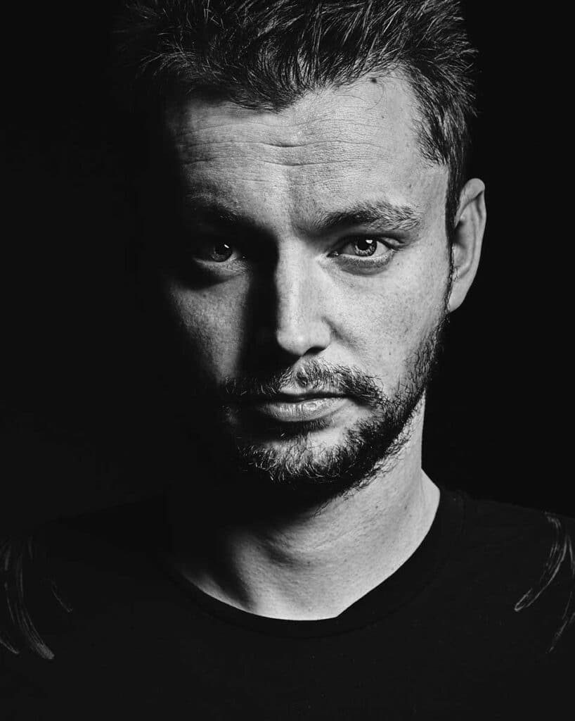editorial photo style dark headshot bonn